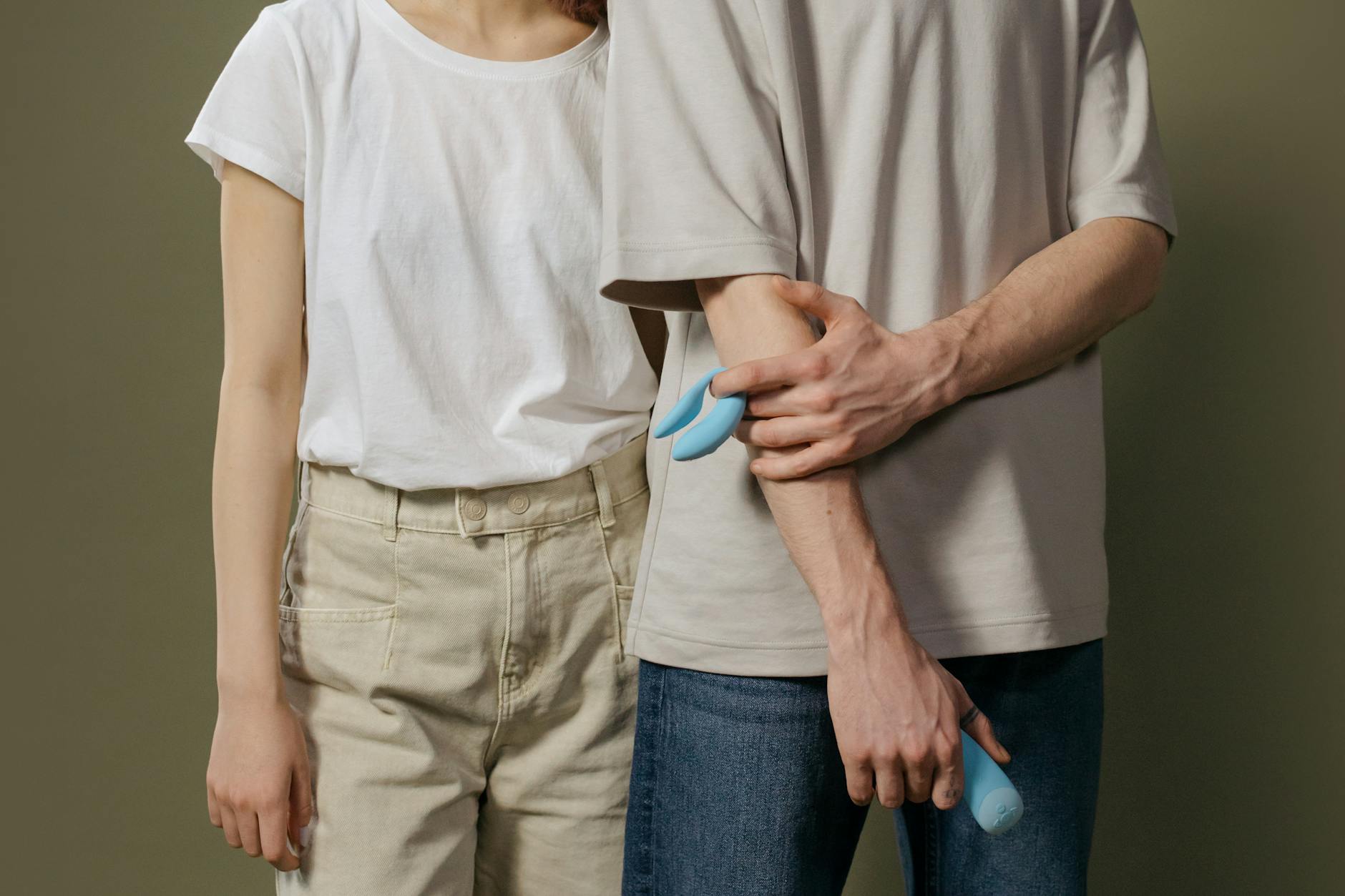 A couple standing together, exploring intimacy and sexual wellness with modern tools
