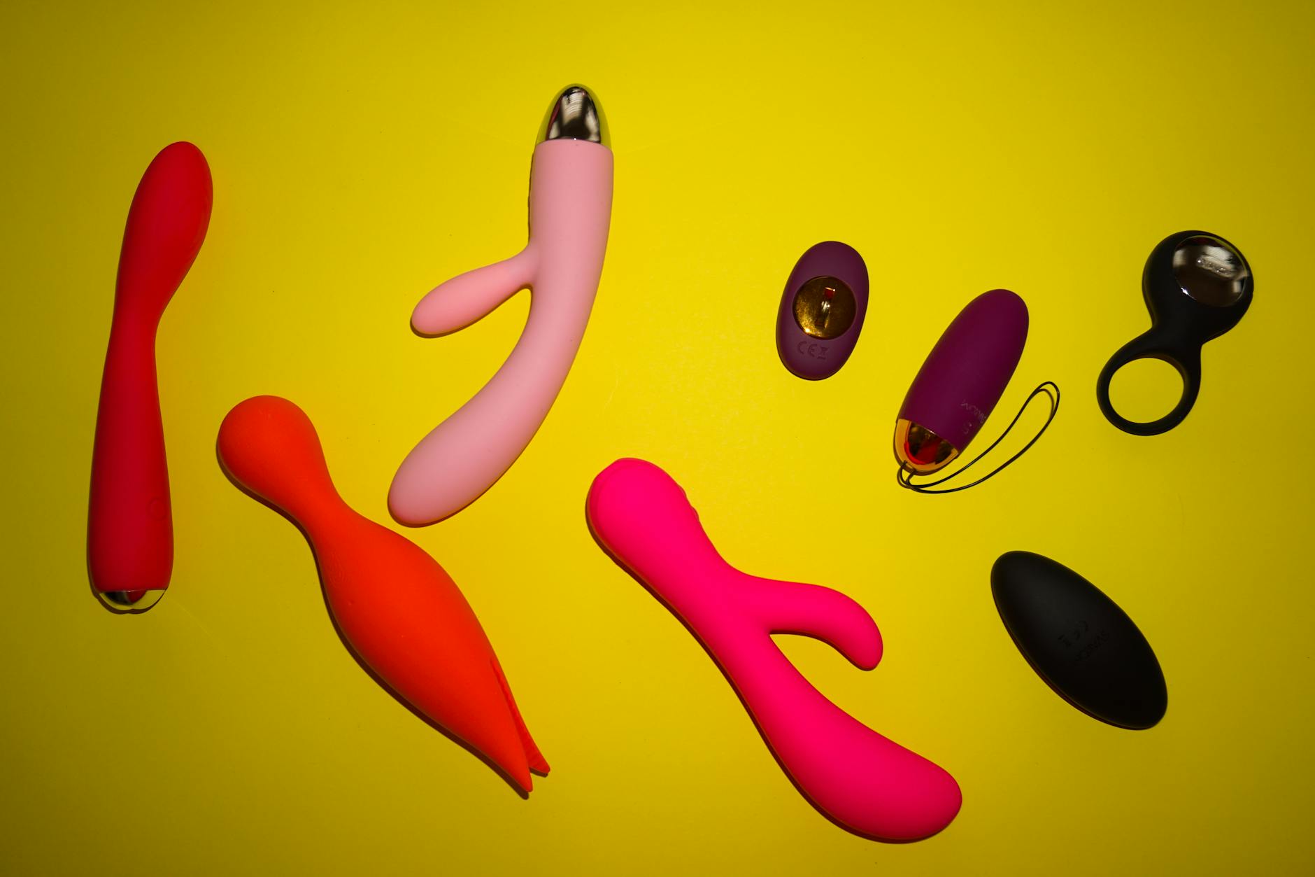 A hand holding a vibrator against a minimalistic backdrop, symbolizing intentional, gentle intimacy